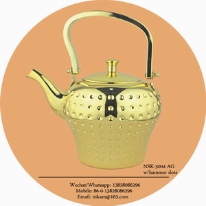 gold tea pot with hammer dots
